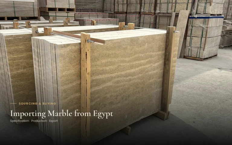 Beige stone slabs held upright between timber supports in a storage yard, with the title Importing Marble from Egypt.