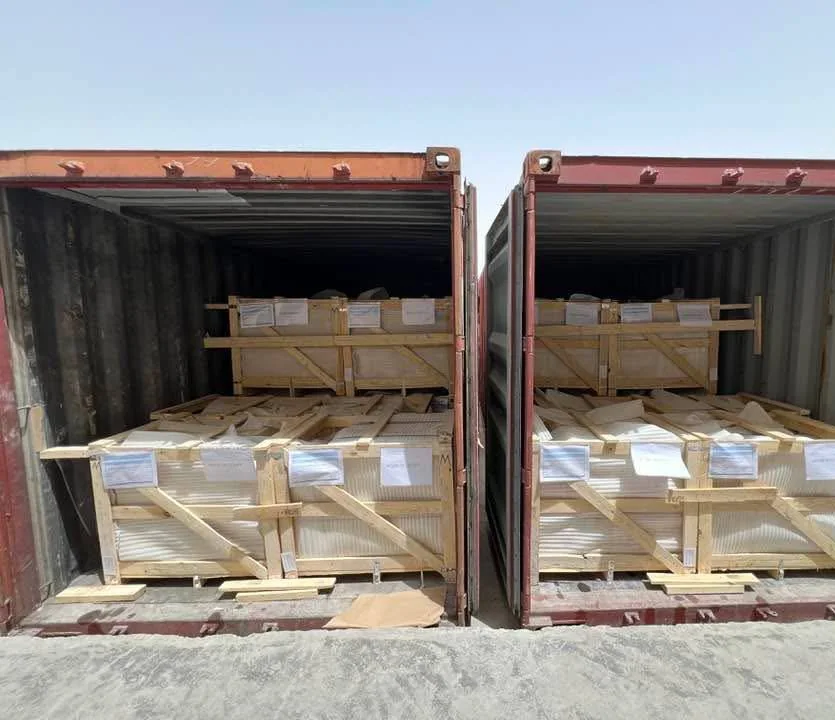 Two open shipping containers with wood-framed packages inside.