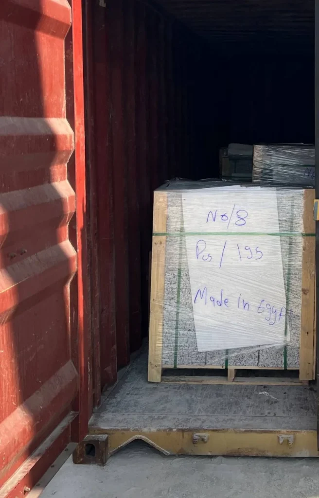 A wrapped stone package marked Made in Egypt inside an open shipping container.