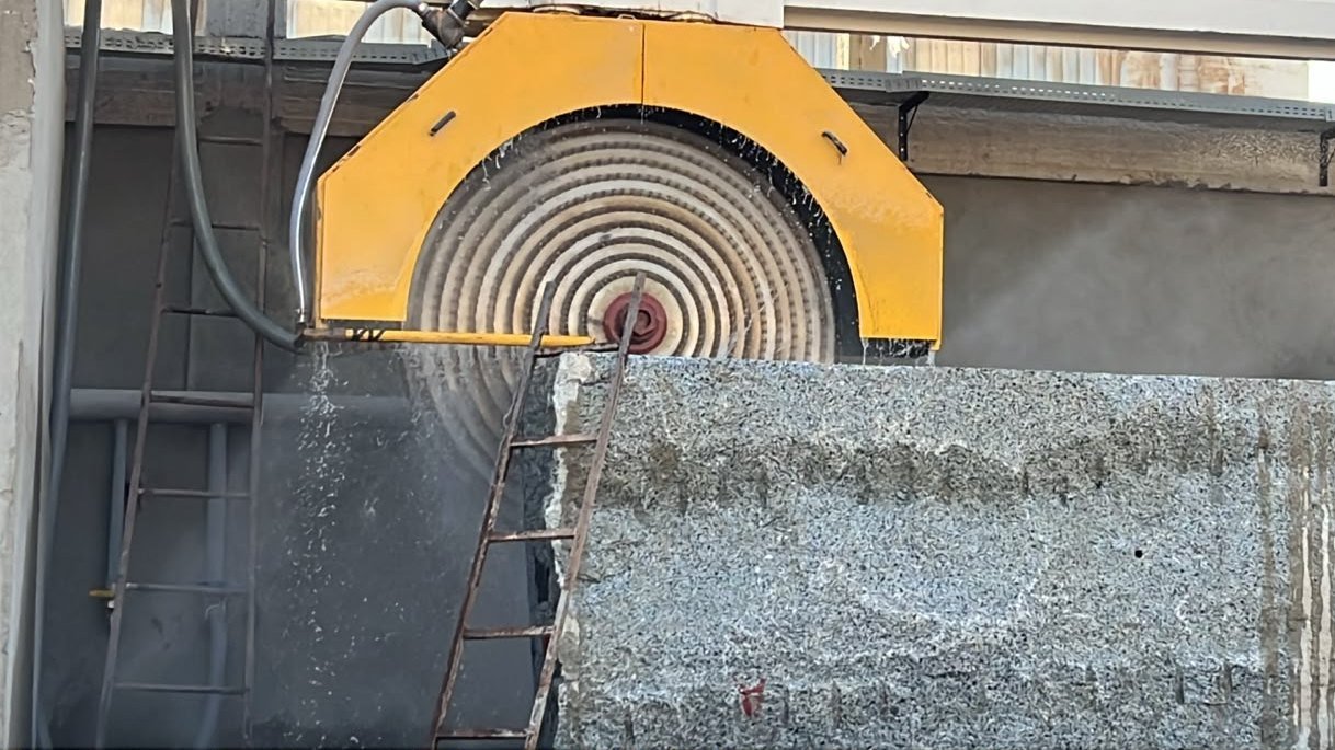 Block saw cutting an Egyptian stone block into slabs
